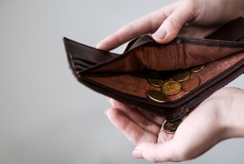 holding purse with coins