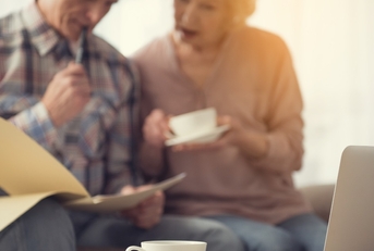 senior couple reviewing documents at home