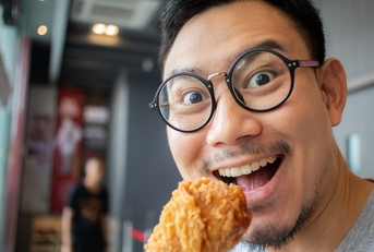 A man eating chicken