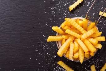 fries scattered on dark background 