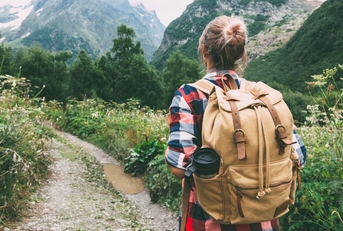 hiker walking to mountains