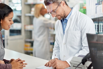 writing prescription at pharmacy