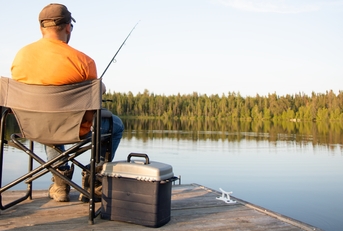man fishing on a lake