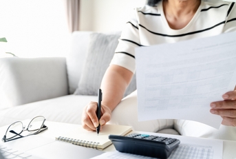woman calculating annual tax 