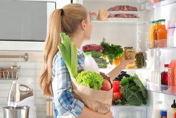 woman putting away groceries