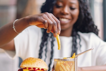 african american woman eating burger