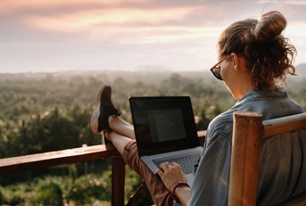 working at a laptop at sunset