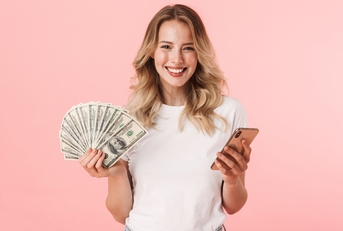 holding money and using phone
