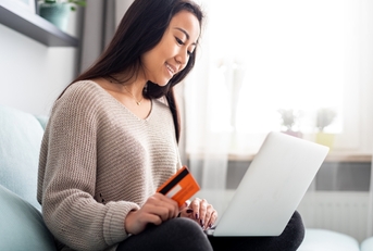 A young woman using a debit card
