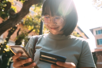 Smiling woman looking at her phone