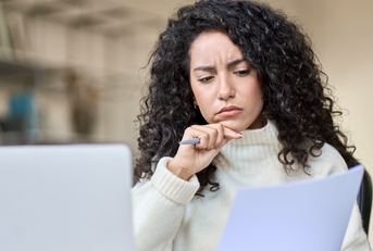 worried female accountant reviewing data