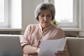senior woman reviewing taxes at home