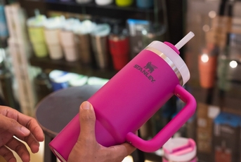 customer holding pink stanley tumbler