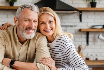 Middle-aged couple smiling at the camera