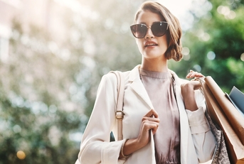 woman holding shopping bags in street