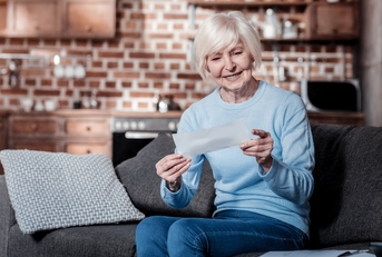 female pensioner reviewing bills at home