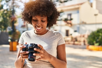 African American female photographer using camera