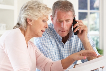 retired couple with household bills