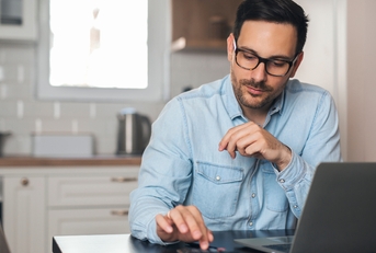 accountant using calculator at home