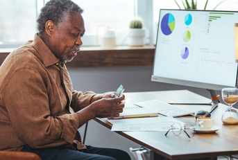 stressed senior man paying bill