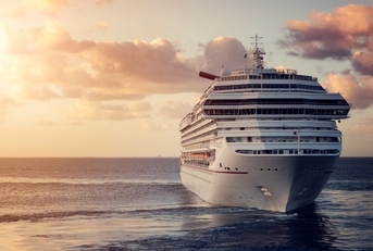 luxury cruise ship leaving port at sunset