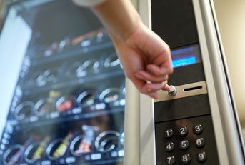 person buying food from vending machine