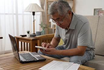 man counting on calculator