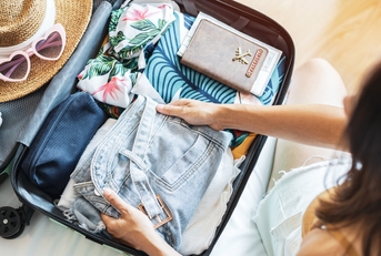 traveler packing her suitcase