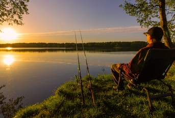 angler sitting on fishing chair 