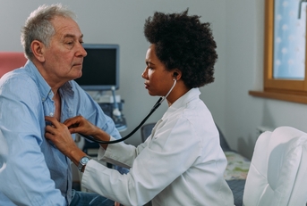 Female doctor examining senior patient
