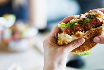 eating vegan meatless burger