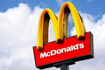 McDonalds logo on blue sky background