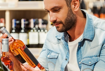 holding a bottle of wine