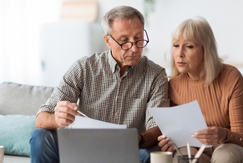 senior couple looking through papers
