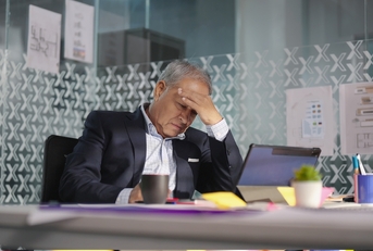 asian manager having headache at work