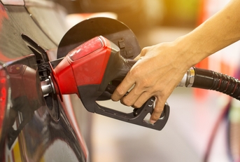 Pumping gas at gas pump
