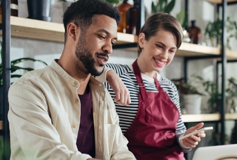 shop assitants using laptop at work