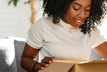woman unpacking parcel cardboard box