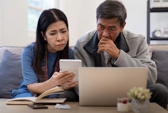 asian couple worried about bill