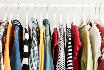Collection of clothes hanging on rack
