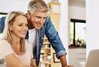happy mature couple using laptop