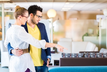 Couple buying couch in furniture store