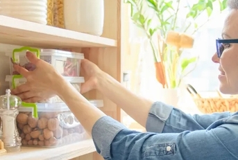 woman setting wooden pantry