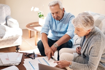 senior couple reviewing investment policy together