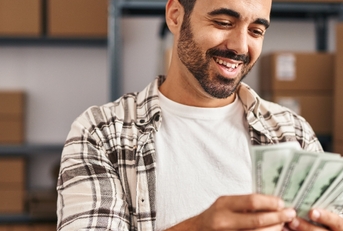Worker counting dollars at office