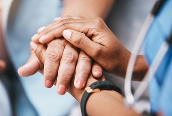nurse holding hands with patient