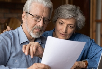 senior couple reviewing insurance policy together