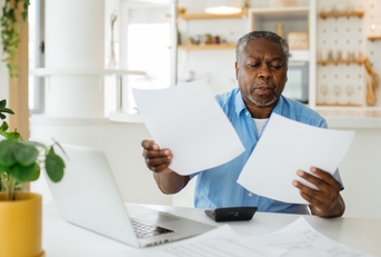 african american retired man reviewing taxes