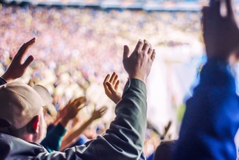 Football fans clapping on the podium