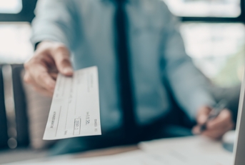 business man giving cheque to customer